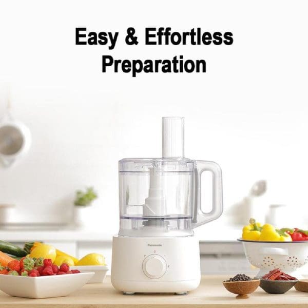 Panasonic MK-F310 white food processor with clear bowl on kitchen counter surrounded by fresh vegetables and fruits, featuring easy preparation capabilities.