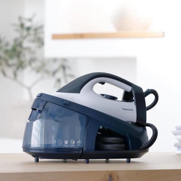 Panasonic NI-GT150ASK steam generator iron with blue and white design, featuring large water tank and iron on wooden surface in modern kitchen setting.
