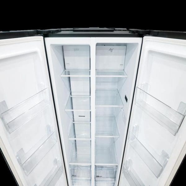Open Panasonic 570L side-by-side refrigerator NR-S621BB-MY showing white interior with multiple shelves, compartments, and freezer sections in both doors.