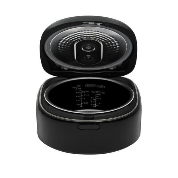 Panasonic SR-DM184KSK black rice cooker with open lid showing interior cooking pot with measurement markings and steam vent on top.