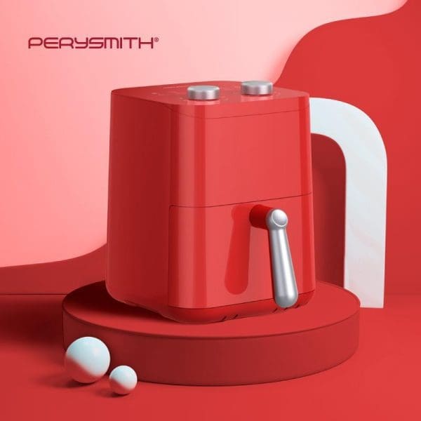 PerySmith PS1530 EcoHealth Series red air fryer with white handle and silver controls, displayed on red circular platform with white spheres against red gradient background.