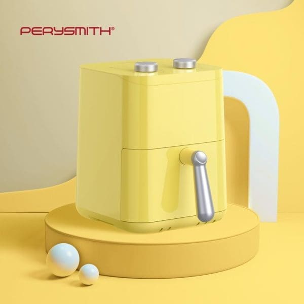PerySmith PS1530 EcoHealth Series yellow air fryer with silver handle and control knobs, displayed on yellow circular platform with white decorative spheres.