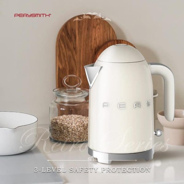 PerySmith KT1010 white electric kettle with wooden accents on kitchen counter, featuring 3-level safety protection, alongside glass storage jar and cutting board.