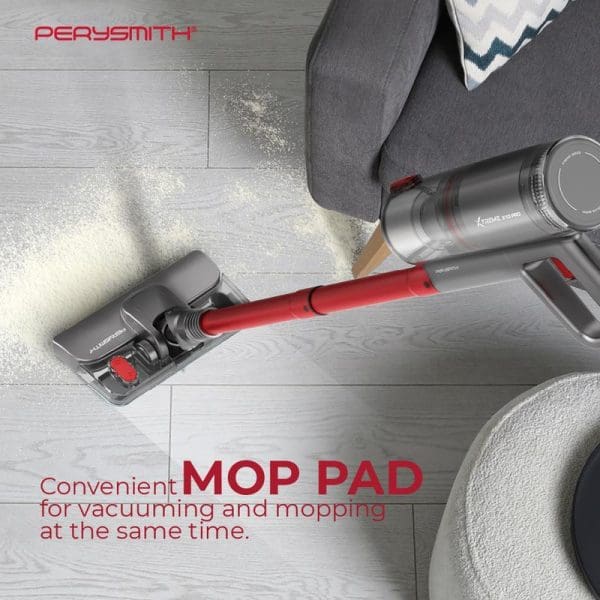 PerySmith Xtreme X10 Pro handheld vacuum cleaner with mop pad attachment cleaning spilled flour on wooden floor near gray sofa and cushions.