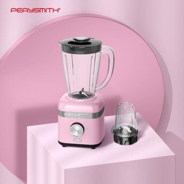 PerySmith PS3250 High Speed Blender in pink with glass pitcher, additional grinding cup attachment, displayed on white platform against pink background.