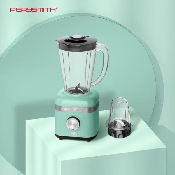 PerySmith PS3250 High Speed Blender in mint green color with clear glass pitcher, black lid, and additional grinding cup on white platform against green background.
