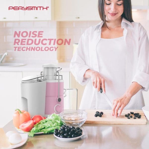 Woman in white shirt using PerySmith pink and white juice extractor in modern kitchen with fresh vegetables and olives on counter, featuring noise reduction technology.