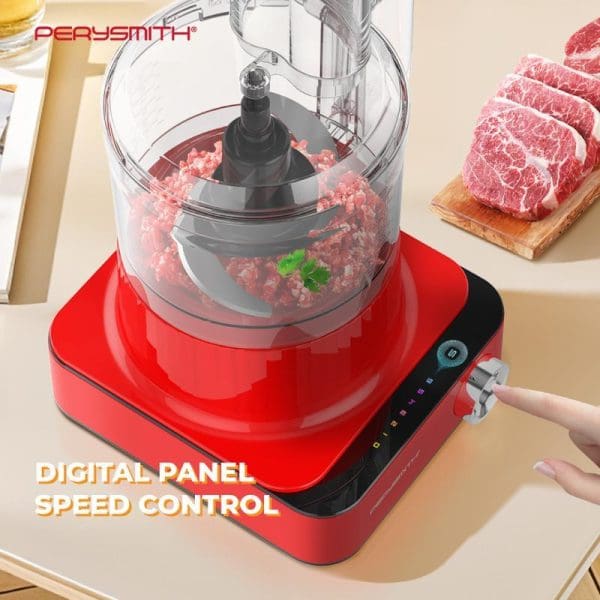 PerySmith PS6500 red food processor with digital speed control processing raw meat, with fresh steaks on cutting board in kitchen setting.