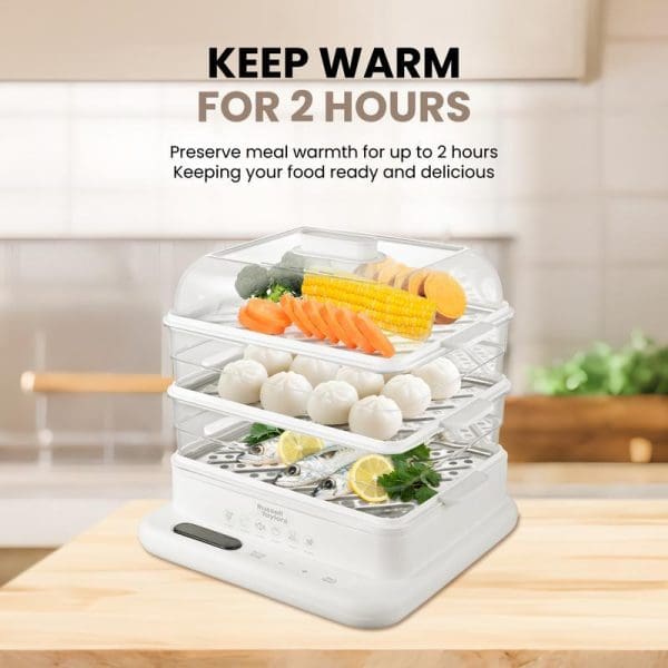 Russell Taylors 3-Tier Food Steamer with vegetables, dumplings, and fish displayed in transparent steaming trays, featuring "Keep Warm for 2 Hours" text overlay.