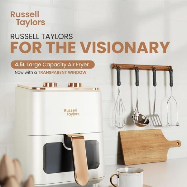Russell Taylors 4.5L large capacity air fryer in white with rose gold accents, featuring transparent window, displayed with kitchen utensils and cutting board.