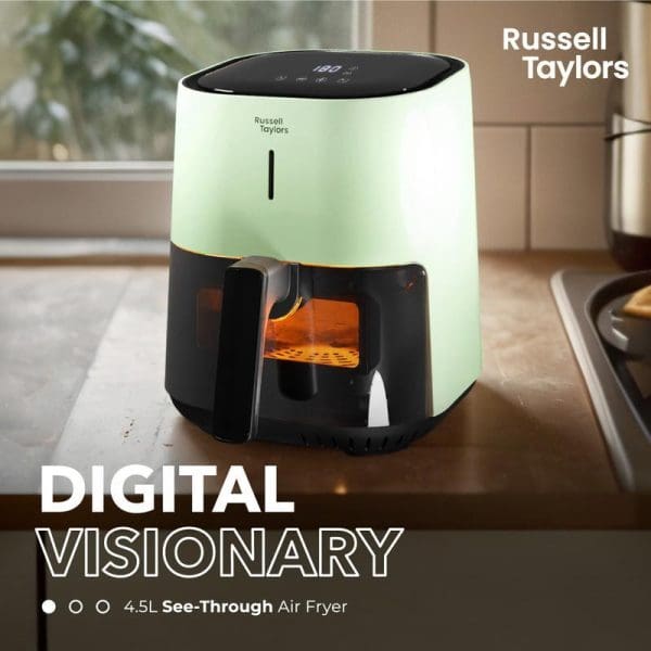 Russell Taylors Digital Visionary 4.5L See-Through Air Fryer in mint green color with black digital display, positioned on kitchen counter with orange glow from cooking chamber visible.