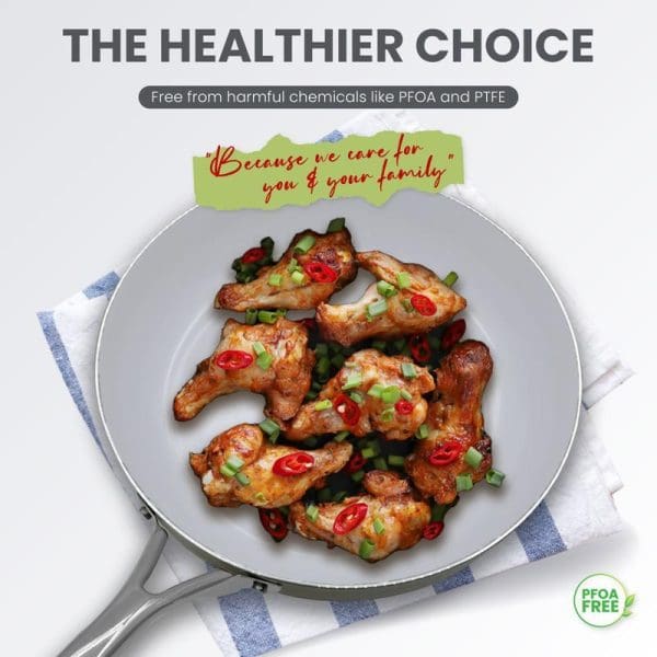 Cooked chicken wings with red peppers and green onions in a gray ceramic non-stick frying pan, promoting PFOA-free healthier cookware choice.