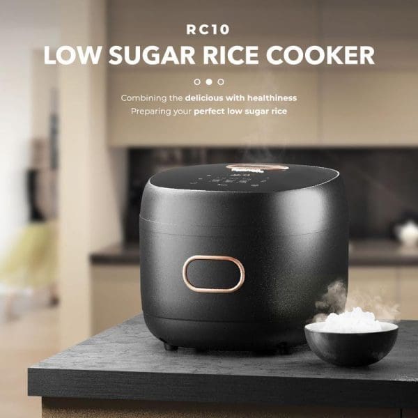 Russell Taylors RC10 Digital Low Sugar Rice Cooker 1.8L in black with copper accents on kitchen counter, featuring cooked rice bowl and modern design.
