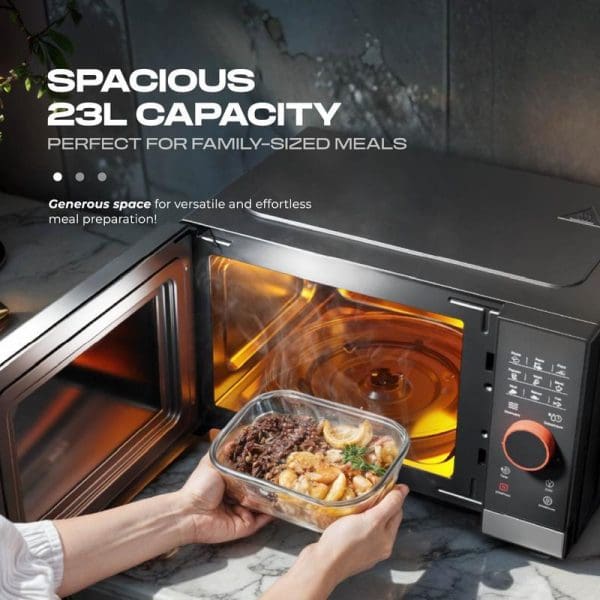 Russell Taylors Digital Microwave Oven 23L M8 with open door showing spacious interior, hands placing glass food container inside, digital control panel visible.