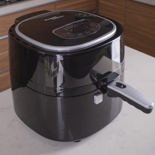 Russell Taylors Digital Rotary Air Fryer AF-76 7.5L in black with digital display panel and handle, positioned on white kitchen counter.