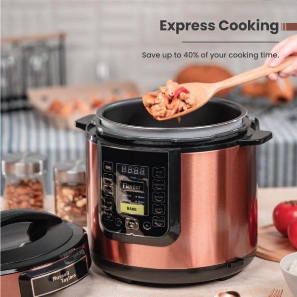 Russell Taylors PC-60 6L electric pressure cooker in copper finish with digital display, wooden spoon with food, kitchen counter setting.