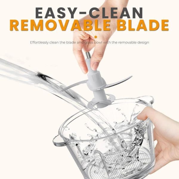 Russell Taylors FC1 Food Chopper with removable blade being cleaned under running water in glass bowl, demonstrating easy-clean design feature.