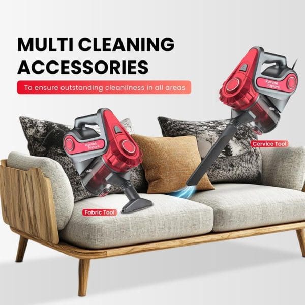 Russell Taylors VC-20 red handheld cyclone vacuum cleaner with multiple cleaning accessories including fabric tool and crevice tool demonstrated on modern grey sofa.