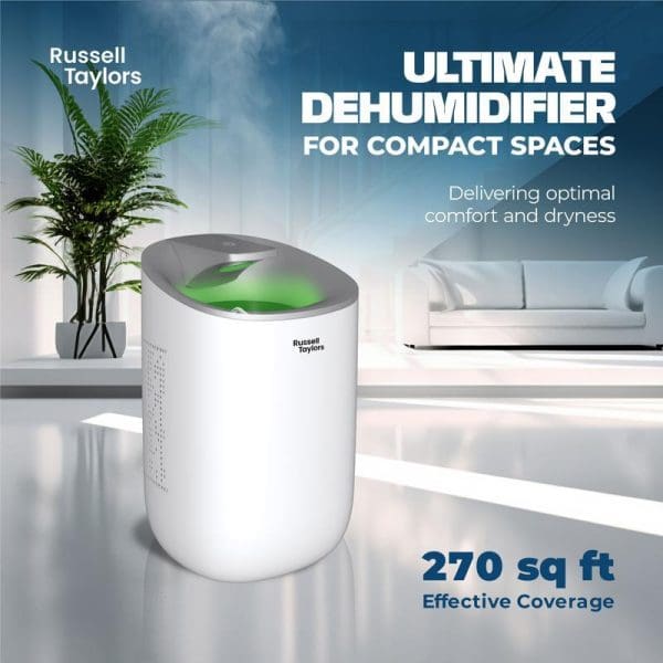 Russell Taylors white compact dehumidifier with green LED light and 600ml water tank in modern living room, covering 270 sq ft effective area.