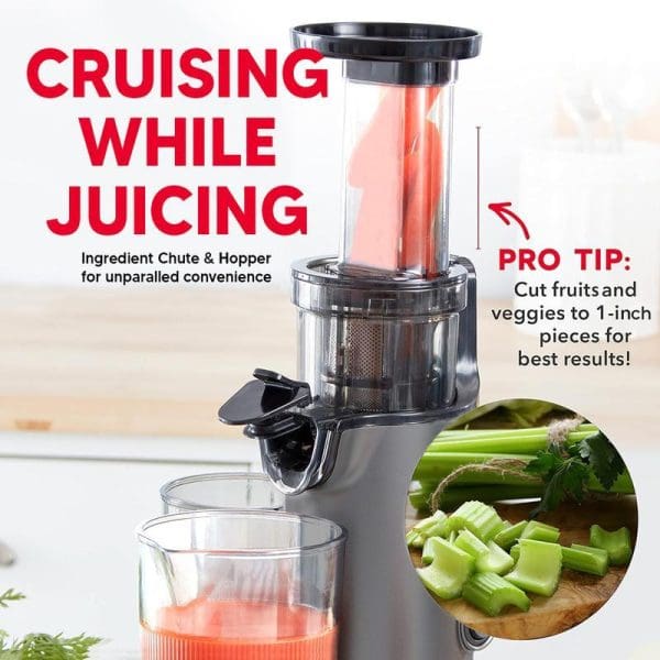 Russell Taylors Masticating Cold Press Compact Slow Juicer SJ1 with ingredient chute and hopper, extracting red juice into glass with chopped celery on cutting board.