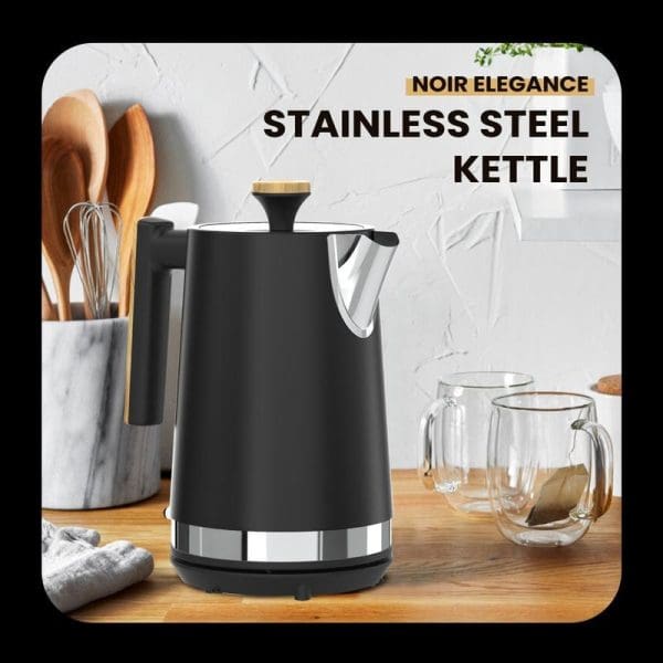 Russell Taylors Noir black stainless steel electric kettle 1.7L RK30 on wooden counter with kitchen utensils and glass mugs in modern kitchen setting.