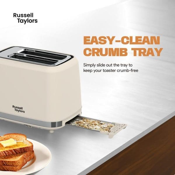 Russell Taylors RT-10 cream retro toaster with easy-clean slide-out crumb tray extended, showing toasted bread on plate beside it on white counter.