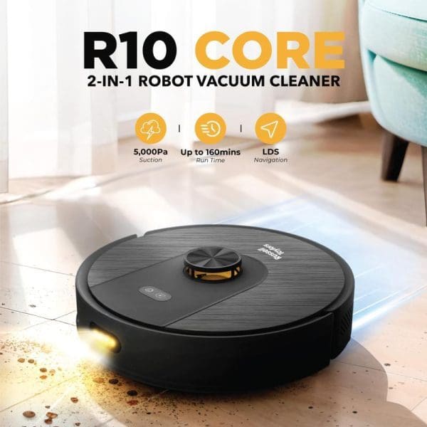Russell Taylors R10 Core 2-in-1 robot vacuum cleaner with black circular design, LDS navigation, 5000Pa suction, 160-minute runtime, cleaning debris on wooden floor.