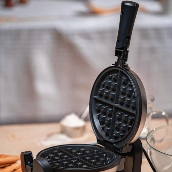 Russell Taylors Rotating Waffle Maker WM-30 open on kitchen counter showing non-stick waffle plates with classic waffle pattern and rotating handle mechanism.