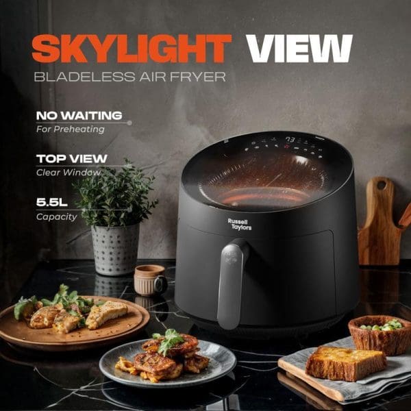 Russell Taylors Skylight View Bladeless Air Fryer 5.5L with clear top window, no preheating needed, surrounded by cooked food on kitchen counter.