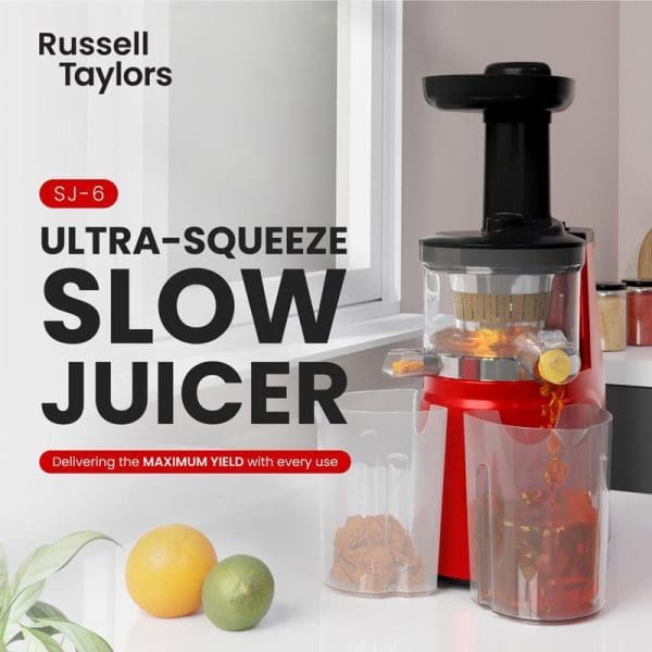 Russell Taylors SJ-6 Ultra-Squeeze Slow Juicer in red and black extracting orange juice, with fresh fruits nearby on white kitchen counter.
