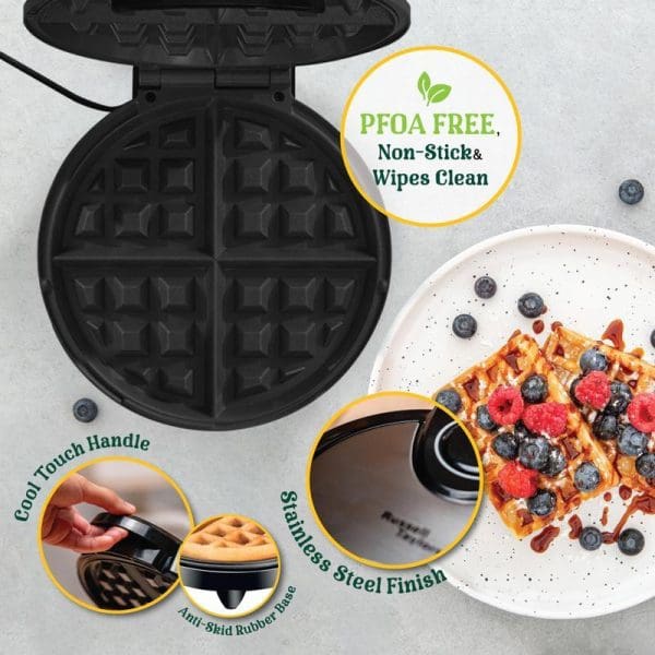 Russell Taylors WM-25 Belgian Waffle Maker with open non-stick plates, PFOA-free coating, cool-touch handle, stainless steel finish, and waffle topped with berries.
