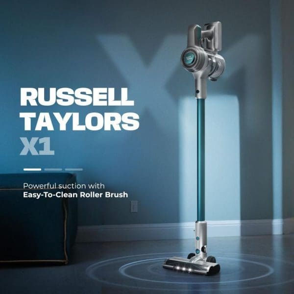 Russell Taylors X1 cordless stick vacuum cleaner with roller brush attachment standing upright on dark floor with blue ambient lighting and product text.