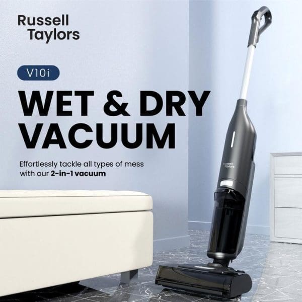 Russell Taylors V10i Wet & Dry Vacuum Cleaner in silver and black, standing upright on marble floor next to white furniture in modern room.