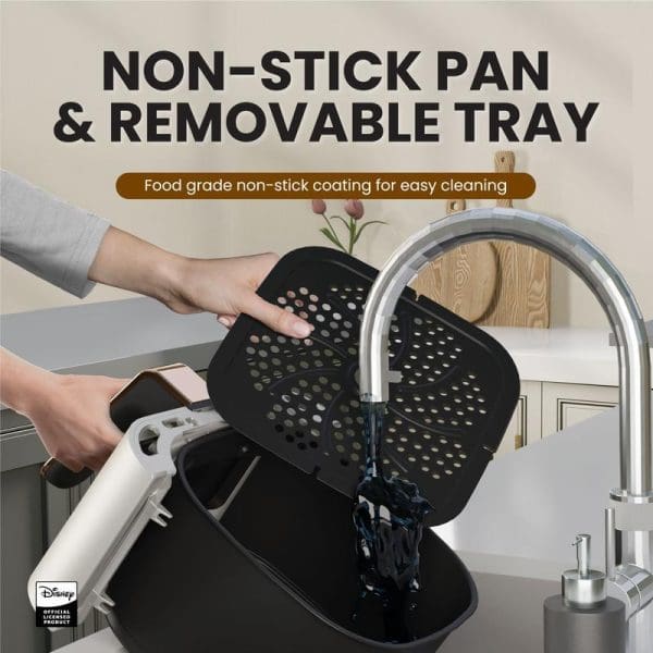 Russell Taylors Disney Mickey Air Fryer with non-stick pan and removable tray being washed under kitchen faucet, featuring food-grade coating for easy cleaning.