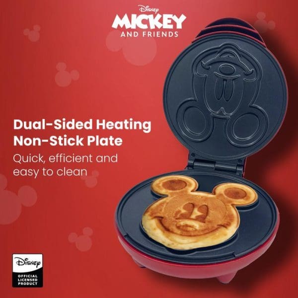 Disney Mickey Mouse waffle maker with dual-sided heating non-stick plate, showing Mickey-shaped waffle inside red and black appliance on red background.
