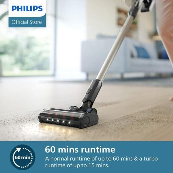 Pembersih vakum tanpa wayar Philips XC3133 dengan masa operasi 60 minit, menunjukkan kepala pembersih berlampu LED sedang membersih permaidani di ruang tamu moden.