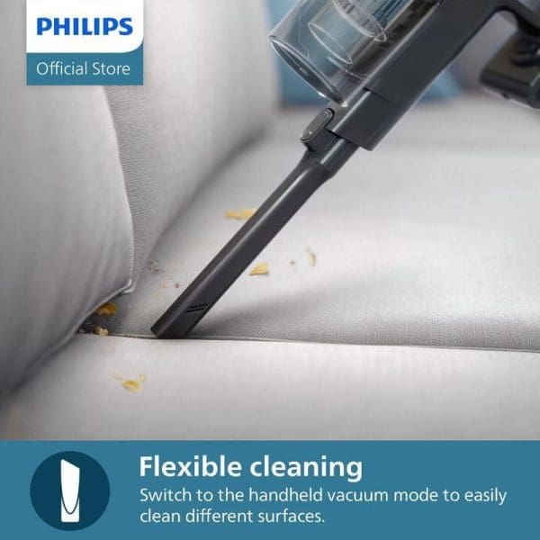 Philips XC3133 Vacuum Cordless sedang membersihkan serpihan makanan di sofa putih dengan mod genggam yang fleksibel untuk pembersihan permukaan berbeza.
