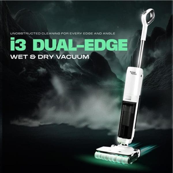 Russell Taylors i3 Dual-Edge Wet & Dry Vacuum putih dengan teknologi pembersihan tanpa halangan untuk setiap sudut dan sudut pada latar belakang hijau gelap dramatis.
