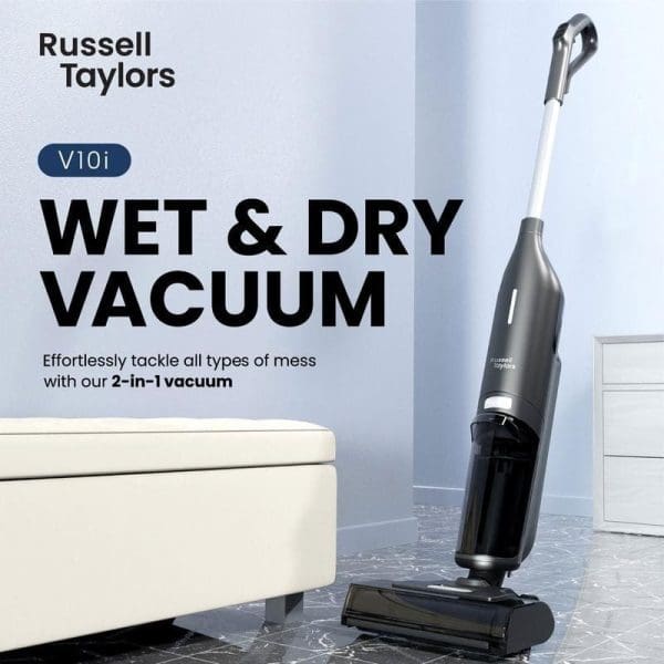 Russell Taylors V10i Wet & Dry Vacuum Cleaner berwarna kelabu dalam bilik moden dengan kerusi putih dan lantai marmar.